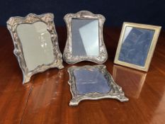 A miscellaneous collection of English hallmarked silver frames. Largest H.30 W.25cm