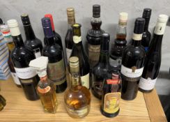 A miscellaneous collection of unopened bottles of wines and spirits.
