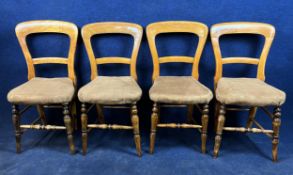 A set of four Victorian beech side chairs in faux leather upholstery.