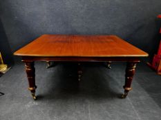 A large and impressive William IV mahogany extending dining table with three extra leaves raised