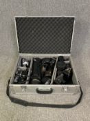 A hard case containing four Minolta 35mm SLR cameras together with a selection of lenses by Hoya,