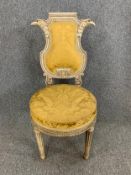 A C.1900 Louis XVI style painted salon chair with eagle head cresting in damask upholstery raised on