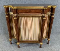 A Regency faux rosewood and parcel gilt chiffonier with pleated panels behind glazed panel doors. (