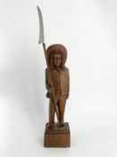A carved oak American folk art pioneer standing figure. H.53cm