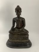 A 19th century bronze seated Buddha figure on ebonised wooden plinth base. H.46cm