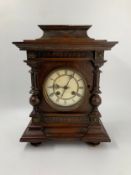 A late 19th century German oak cased mantel clock. H.41cm