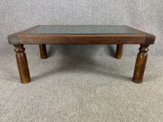An Eastern carved hardwood coffee table with inset plate glass top. H.36 W.94 D.59cm