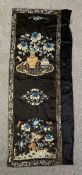 A Chinese embroidery on silk, flowers and blossom in a stylised border. H.146 W.57cm