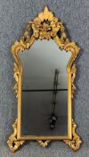 A 19th century style carved giltwood wall mirror. H.110 W.54cm