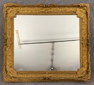 A 19th century carved giltwood and gesso wall mirror. H.93 W.105cm