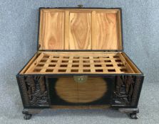 An early 20th century Chinese carved camphorwood coffer with lift-out linen tray. H.54 W.101 D.56cm