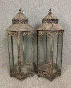 A pair of 19th century style metal floor standing storm lanterns. H.95cm (each)
