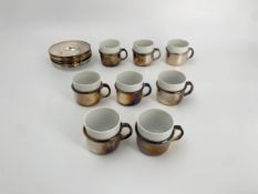 A set of vintage coffee cups and saucers marked Hollandia Plate, 8 cups and 12 saucers. H.5cm (each)