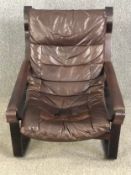 A 1970's vintage Danish armchair in leather upholstery and a laminated frame. H.95 W.73 D.100cm.