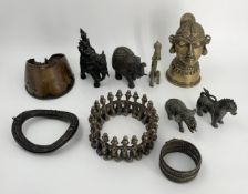 A miscellaneous collection of Eastern and African tribal metal and brass items. H.17cm (largest)