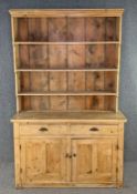 A 19th century pine farmhouse dresser, in two sections. H.228 W.145 D.46cm