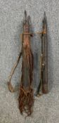 Two 19th or early 20th century African carved and leather bound quivers with collection of tribal
