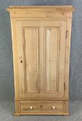 A 19th century pine wardrobe fitted with base drawer. H.173 W.51 D.97cm