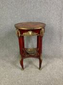 A mahogany Empire style lamp or occasional table with scrolling foliate inlay and brass and ormolu