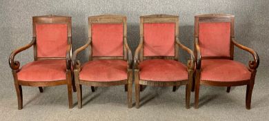A set of four 19th century Empire style mahogany armchairs in studded velour upholstery raised on