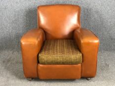 A mid century Art Deco style armchair in it's original faux leather and fabric upholstery. H.78 W.76