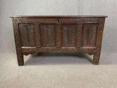 An 18th century oak coffer, well carved all over. H.75 W.131 D.56cm