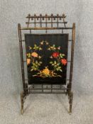 A 19th century bamboo firescreen with Chinese motifs and a wild rose embroidered central panel. H.
