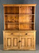 A 19th century pine two section kitchen dresser. W.152 H.209 D55cm.