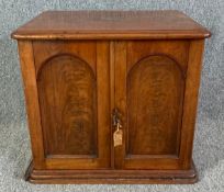 A 19th century mahogany and brass inlaid cutlery cabinet with panel doors enclosing fitted
