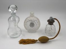 Three perfume bottles: one vintage silver lidded with atomiser, one large blotter bottle signed