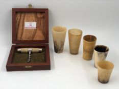 A boxed silver corkscrew marked 900 along with a graduating set of horn beakers. H.10cm.