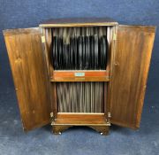 An early 20th century fitted gramophone record cabinet with maker's label along with an extensive