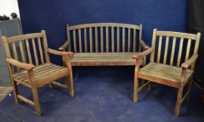 A weathered teak garden bench and matching armchairs. H.90 W.127 D.55cm