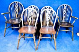 A set of six mahogany Windsor wheelback dining chairs to include two carver elbow chairs.