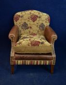 A contemporary leather and fabric upholstered armchair.
