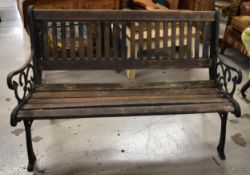 A cast iron and slatted Victorian style garden bench. H.82 W.127 D.56cm