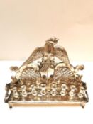 A late 19th century Austro-Hungarian repousse silver Hanukkah menorah, eagle motif to the top and