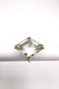 A 9ct yellow gold aquamarine cocktail ring set with a cut-cornered lozenge cut aquamarine,