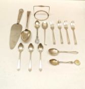 A collection of silver cutlery, including cake forks, tea spoons and a 19th century serving spoon.