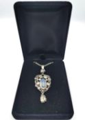 An Arts and Crafts white metal (tests as silver) Liberty & Co. moonstone set foliate design drop