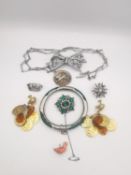 A collection of jewellery, including a carved coral duck charm, a silver crown brooch, two Victorian