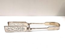 A pair of Victorian pierced foliate design silver asparagus tongs by John Aldwinckle & Thomas