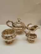 A Georgian and Victorian silver three piece non matching tea set. The tea pot and milk jug by Samuel