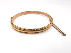 An Edwardian 9ct rose gold bangle by A J Pepper & Co, fancy beaded detailing to the D-shaped bangle,