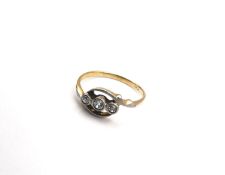 A boxed Edwardian yellow metal (tests as higher than 14ct) three stone diamond ring, set with