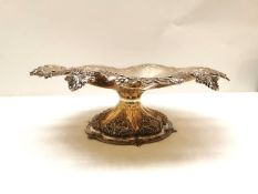 A Victorian Robert Garrard II repousse silver pedestal dish with scalloped foliate design edge and