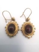 A pair of Etruscan revival yellow metal (tests as 14ct) gold carbuncle garnet earrings, each of