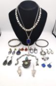 A collection of silver and white metal jewellery, including a Victorian style silver book chain, a