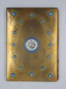 A 19th century engraved gilt metal blotter with hand decorated Sevres style central panel. H.26 W.