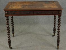 A Victorian mahogany writing table with leather inset top raised on barleytwist supports terminating